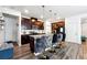 Stylish kitchen with dark cabinets, an island with bar stools, and wood flooring at 1405 Lyon Way Dr, Lawrenceville, GA 30044