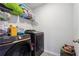 Functional laundry room equipped with modern appliances, shelving for storage, and convenient tile flooring at 1405 Lyon Way Dr, Lawrenceville, GA 30044