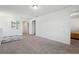 Bright neutral colored carpeted loft with open doorways to other rooms at 1405 Lyon Way Dr, Lawrenceville, GA 30044