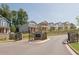 A street view of the Sweetwater Farms neighborhood entrance, featuring stylish two-story homes at 1405 Lyon Way Dr, Lawrenceville, GA 30044