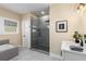 Bright and airy bathroom featuring a glass-door shower, tub, and a sleek white vanity at 1985 Lois Pl, Atlanta, GA 30318