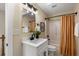 Well-lit bathroom with a modern vanity, sleek fixtures, and a shower with stylish curtain at 1985 Lois Pl, Atlanta, GA 30318