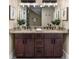 Double sink bathroom with granite countertops, dark wood cabinets, and modern fixtures at 1985 Lois Pl, Atlanta, GA 30318