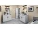 Luxury bathroom featuring dual sinks with white vanities, natural light, and a soaking tub at 1985 Lois Pl, Atlanta, GA 30318