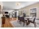 Bright dining room area with hardwood floors, natural light, and an open view to the kitchen and living room at 1985 Lois Pl, Atlanta, GA 30318