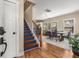 Inviting entryway with hardwood floors, staircase with iron spindles, and a view of the dining area with natural light at 1985 Lois Pl, Atlanta, GA 30318