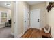 Inviting hallway with hardwood floors and a view into a room with a bright window at 1985 Lois Pl, Atlanta, GA 30318
