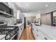 Bright kitchen with a gas range stove, stainless steel appliances and a long island with white countertops at 1985 Lois Pl, Atlanta, GA 30318