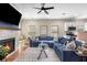 Spacious living room with hardwood floors, stone fireplace, large blue sofa, and a view of the adjacent kitchen at 1985 Lois Pl, Atlanta, GA 30318