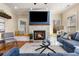 Bright living room with a stone fireplace, hardwood floors, recessed lighting, and a comfortable blue sofa at 1985 Lois Pl, Atlanta, GA 30318