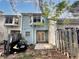 Exterior view of a home's backyard, featuring a patio and partial fencing at 5916 Dogwood Mnr, Lithonia, GA 30038