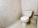 Powder room with a white toilet and floral wallpaper at 5916 Dogwood Mnr, Lithonia, GA 30038