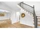 Bright and airy foyer showcasing hardwood floors, wainscoting, and a staircase with wrought iron balusters at 770 Bedford Oaks Dr, Marietta, GA 30068