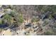 Aerial view of wooded property showcasing two houses and driveways at 115 Hollybrook Rd, Atlanta, GA 30349