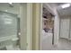 Hallway view showcasing a full bathroom with tiled shower and separate laundry area with water heater at 115 Hollybrook Rd, Atlanta, GA 30349