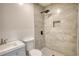 Modern bathroom featuring tile walls, a rainfall shower head, and a gray vanity at 115 Hollybrook Rd, Atlanta, GA 30349
