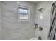 Bright bathroom featuring marble wall tiles and shower with a tiled backsplash at 115 Hollybrook Rd, Atlanta, GA 30349
