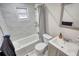 Bright bathroom featuring marble wall tiles, vanity, and tub with shower at 115 Hollybrook Rd, Atlanta, GA 30349