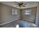 Empty bedroom with neutral walls, two windows and ceiling fan at 115 Hollybrook Rd, Atlanta, GA 30349