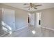Empty bedroom with neutral walls, two windows, wood floors, and ceiling fan at 115 Hollybrook Rd, Atlanta, GA 30349