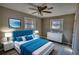 Stylishly furnished bedroom features wood floors, ceiling fan, and beach themed decor at 115 Hollybrook Rd, Atlanta, GA 30349