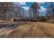 One-story home with mature trees surrounding the property, offering a peaceful setting at 115 Hollybrook Rd, Atlanta, GA 30349