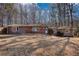Charming one-story home with a brick accent and mature trees surrounding the property at 115 Hollybrook Rd, Atlanta, GA 30349