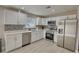 Well-lit kitchen featuring stainless steel appliances, white cabinetry, and a stylish tile backsplash at 115 Hollybrook Rd, Atlanta, GA 30349