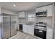 Well-lit kitchen featuring stainless steel appliances, white cabinets, and light countertops at 115 Hollybrook Rd, Atlanta, GA 30349