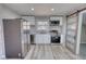 Well-lit kitchen featuring stainless steel appliances, white cabinets, and a sliding barn door at 115 Hollybrook Rd, Atlanta, GA 30349