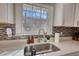 A detailed shot of the kitchen counter with stainless steel sink and faucet, set against a window at 115 Hollybrook Rd, Atlanta, GA 30349