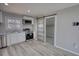Modern kitchen with stainless steel appliances, white cabinets, and a sliding barn door at 115 Hollybrook Rd, Atlanta, GA 30349