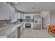Beautiful kitchen featuring white cabinets, stainless steel appliances and modern backsplash, in an open layout at 115 Hollybrook Rd, Atlanta, GA 30349