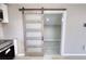 Kitchen area featuring a sliding barn door and modern appliances at 115 Hollybrook Rd, Atlanta, GA 30349