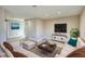 Cozy living room with wood-look floors, a large couch, and a TV at 115 Hollybrook Rd, Atlanta, GA 30349