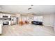 Open-concept living area flows seamlessly into the kitchen, featuring recessed lighting and light-colored flooring at 115 Hollybrook Rd, Atlanta, GA 30349