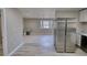 Open living space with wood-look floors, a large window, and access to the kitchen at 115 Hollybrook Rd, Atlanta, GA 30349