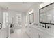 Bright bathroom featuring dual sinks, a glass shower, and a door to the exterior at 425 Burton Dr, Alpharetta, GA 30009