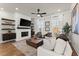 Comfortable living room area featuring a fireplace, large windows, and hardwood floors at 425 Burton Dr, Alpharetta, GA 30009