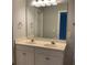 Bathroom featuring a dual sink vanity with a large mirror and white cabinets at 5027 Bayrose Cir # 27A, Atlanta, GA 30344