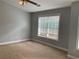 The bedroom features neutral walls, wall to wall carpet, and a large window for natural light at 5027 Bayrose Cir # 27A, Atlanta, GA 30344