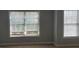 A bedroom with neutral walls and large windows allowing for plenty of natural light at 5027 Bayrose Cir # 27A, Atlanta, GA 30344