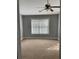 A neutral carpeted bedroom with a ceiling fan and a large window allows for plenty of natural light at 5027 Bayrose Cir # 27A, Atlanta, GA 30344