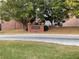 View of community entrance sign with brick facade and manicured landscaping on a tree-lined street at 5027 Bayrose Cir # 27A, Atlanta, GA 30344