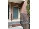 Charming front door of a brick home with gray paint, and a decorative railing on a sunny day at 5027 Bayrose Cir # 27A, Atlanta, GA 30344