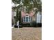 Charming brick townhome featuring a landscaped front yard with a 'For Sale' sign at 5027 Bayrose Cir # 27A, Atlanta, GA 30344