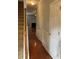 Inviting hallway with hardwood floors and decorative wainscoting, leading to the living room with fireplace at 5027 Bayrose Cir # 27A, Atlanta, GA 30344