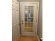 Hallway with wood floors and a door with glass panels letting light in at 5027 Bayrose Cir # 27A, Atlanta, GA 30344