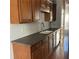 Functional kitchen with wooden cabinets, laminate countertops, stainless steel appliances, and hardwood floors at 5027 Bayrose Cir # 27A, Atlanta, GA 30344
