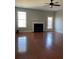 Spacious living room with fireplace, ceiling fan, hardwood flooring and ample natural light at 5027 Bayrose Cir # 27A, Atlanta, GA 30344